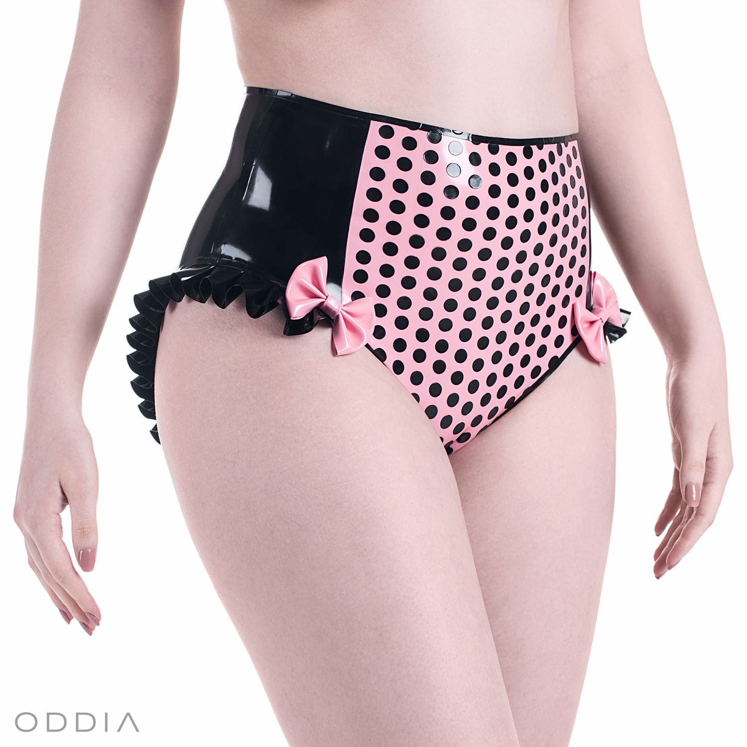 Black high waisted latex panties with a contrasting pink center, adorned with dots, ruffles, and bows